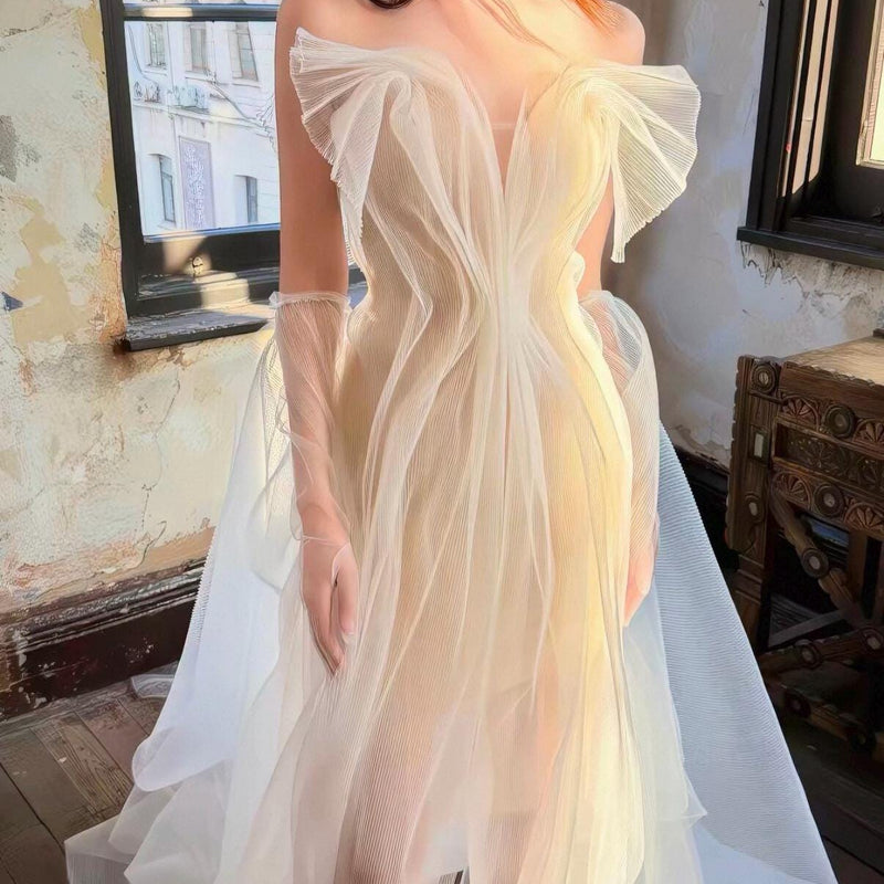 High-fashion engagement/birthday gown featuring intricate pleating, sheer mesh, a sexy open back, and a high-slit maxi skirt.