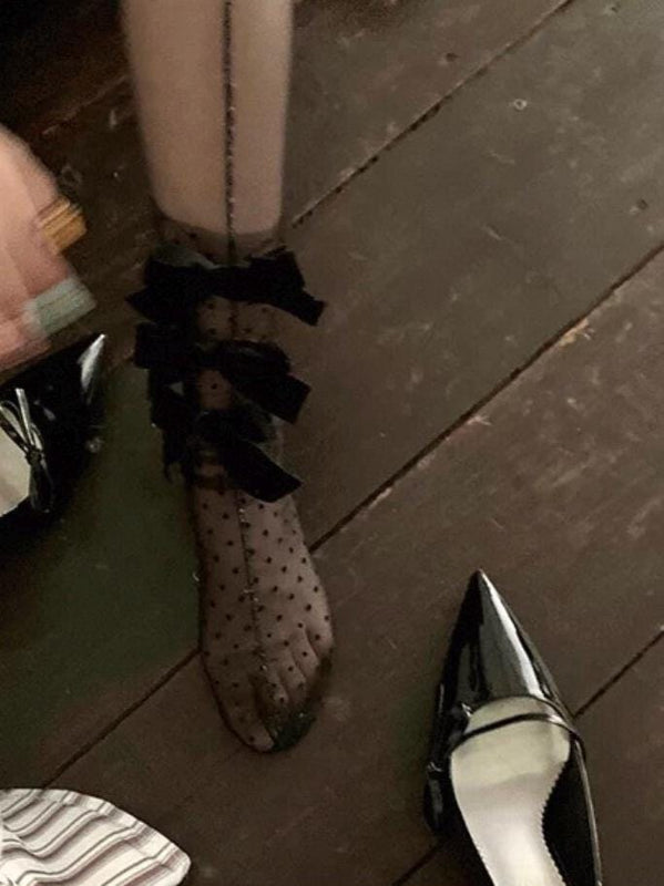 Sheer mid-calf socks featuring a velvet bow, mesh texture, and polka-dot fairy-style design