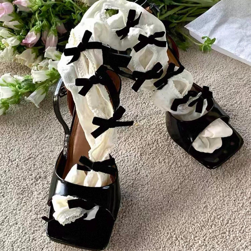 Vintage-style, slimming, over-the-knee socks featuring a flocked bow, cut-out details, and lace accents.