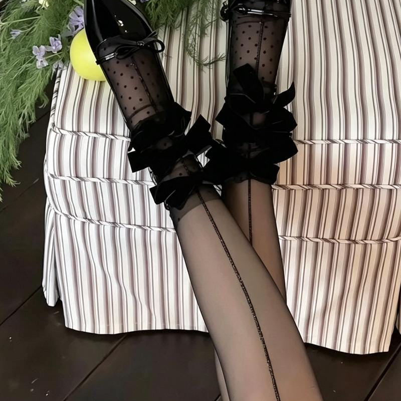Sheer mid-calf socks featuring a velvet bow, mesh texture, and polka-dot fairy-style design