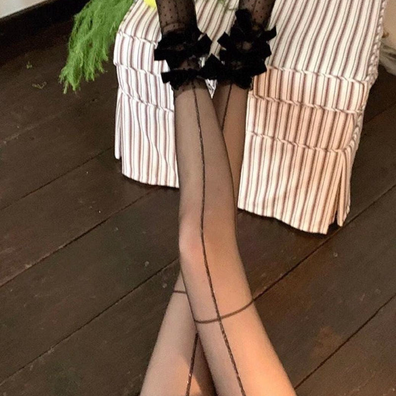 Sheer mid-calf socks featuring a velvet bow, mesh texture, and polka-dot fairy-style design