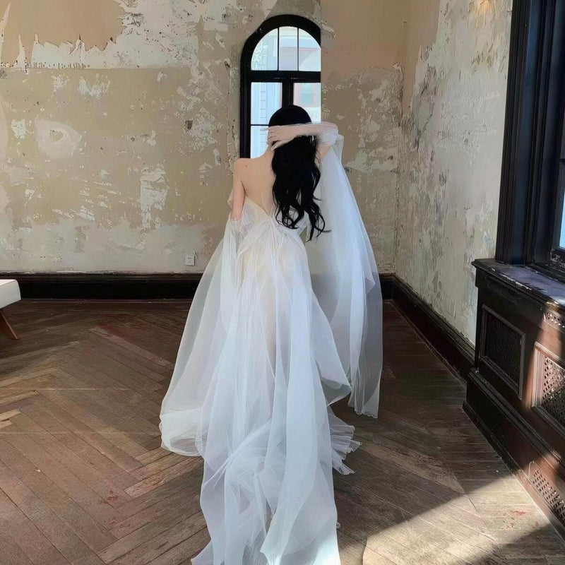 High-fashion engagement/birthday gown featuring intricate pleating, sheer mesh, a sexy open back, and a high-slit maxi skirt.