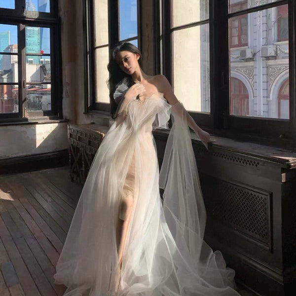 High-fashion engagement/birthday gown featuring intricate pleating, sheer mesh, a sexy open back, and a high-slit maxi skirt.