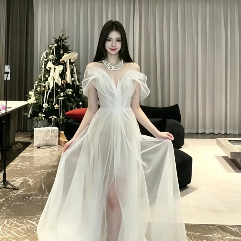 High-fashion engagement/birthday gown featuring intricate pleating, sheer mesh, a sexy open back, and a high-slit maxi skirt.