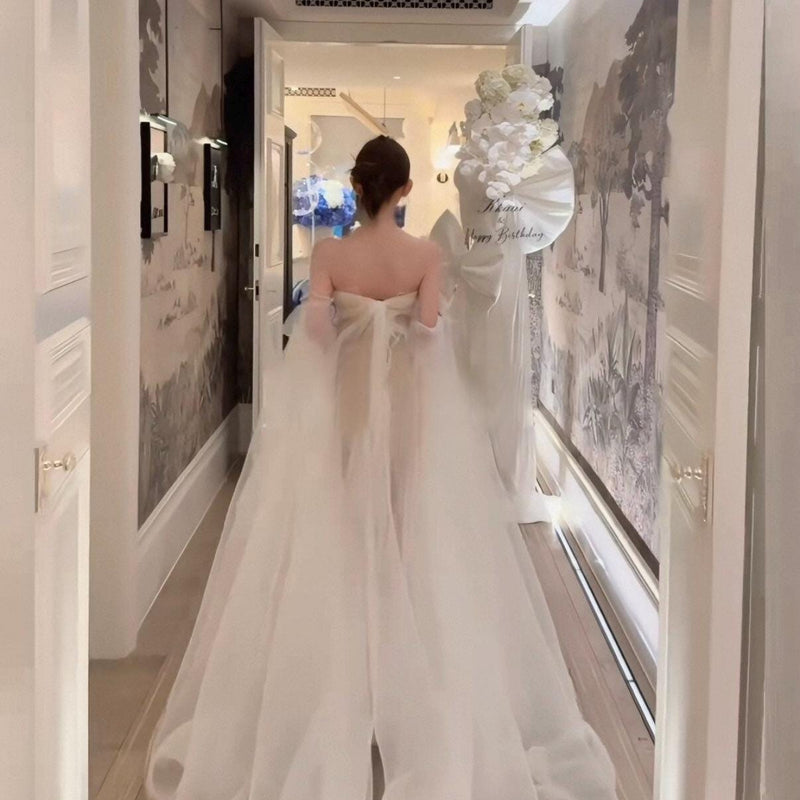 High-fashion engagement/birthday gown featuring intricate pleating, sheer mesh, a sexy open back, and a high-slit maxi skirt.
