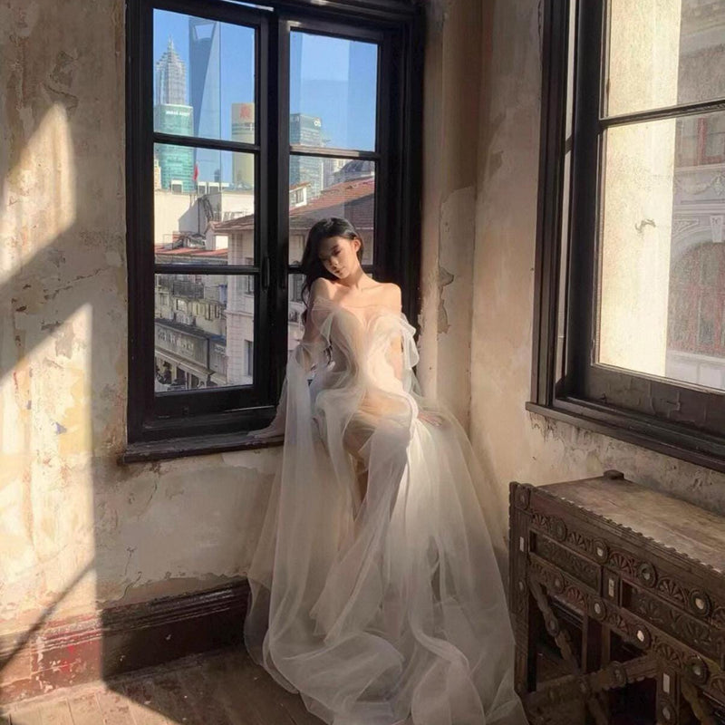 High-fashion engagement/birthday gown featuring intricate pleating, sheer mesh, a sexy open back, and a high-slit maxi skirt.