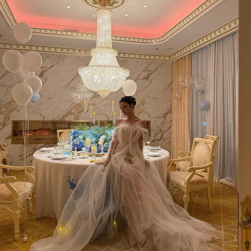 High-fashion engagement/birthday gown featuring intricate pleating, sheer mesh, a sexy open back, and a high-slit maxi skirt.